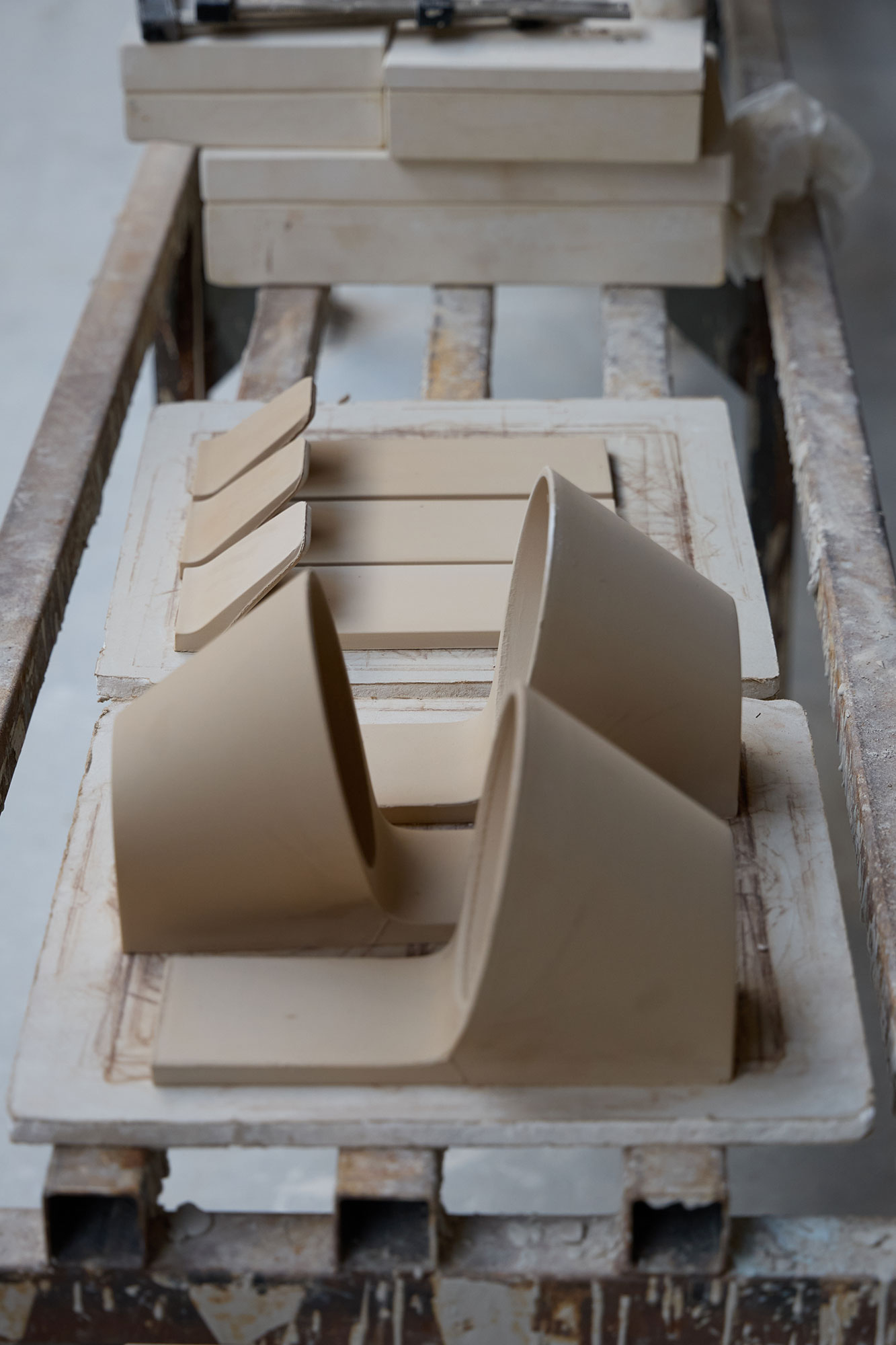 Molded lamps and hooks are drying in the ceramic workshop.